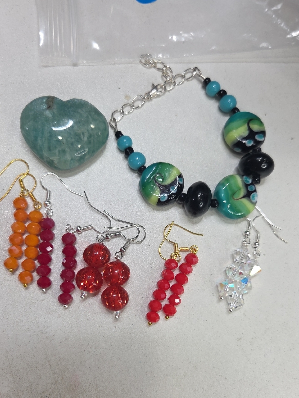 Bundle of earrings bracelet and palm stone